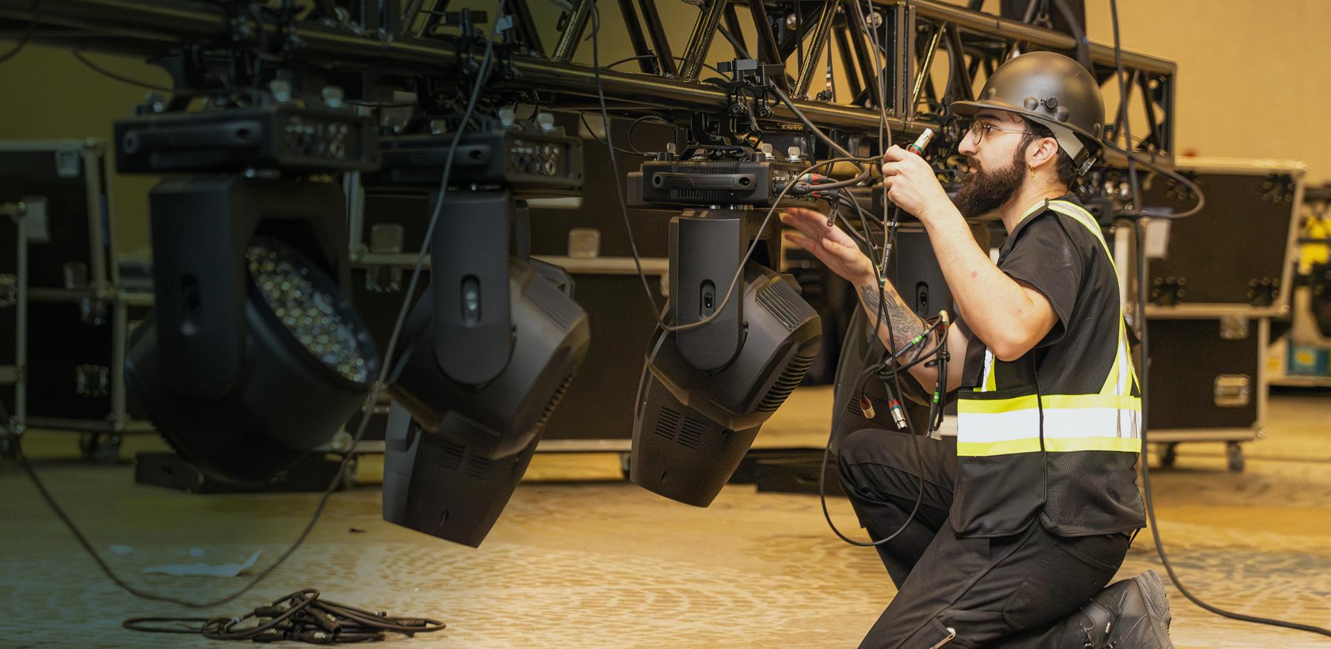 Dmi technician working sound equipment