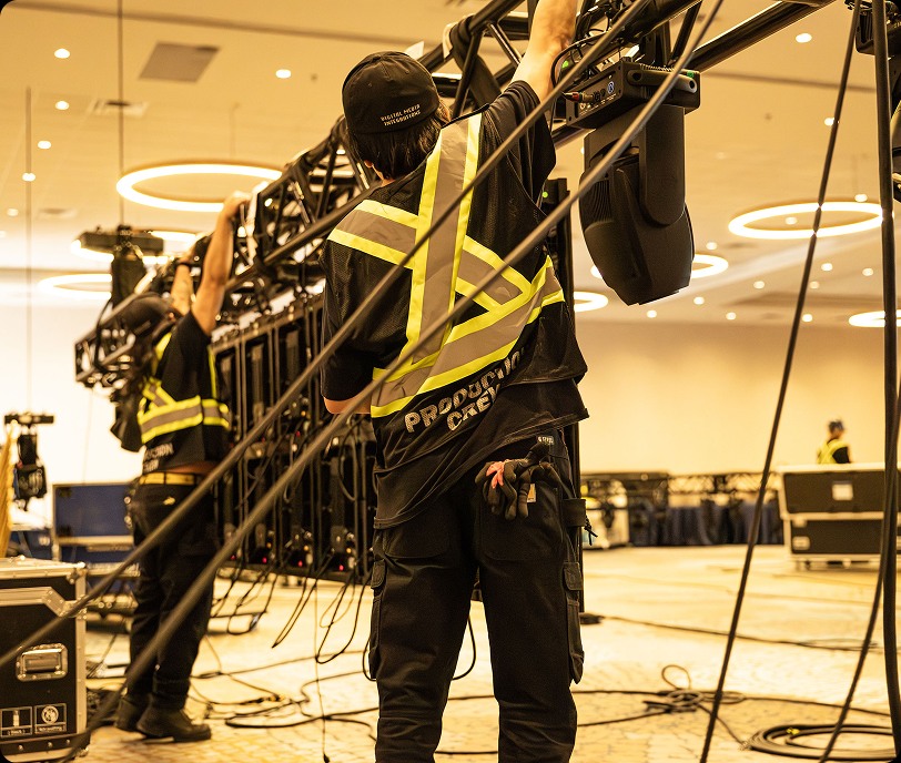 Dmi technicians installing sound equipment event